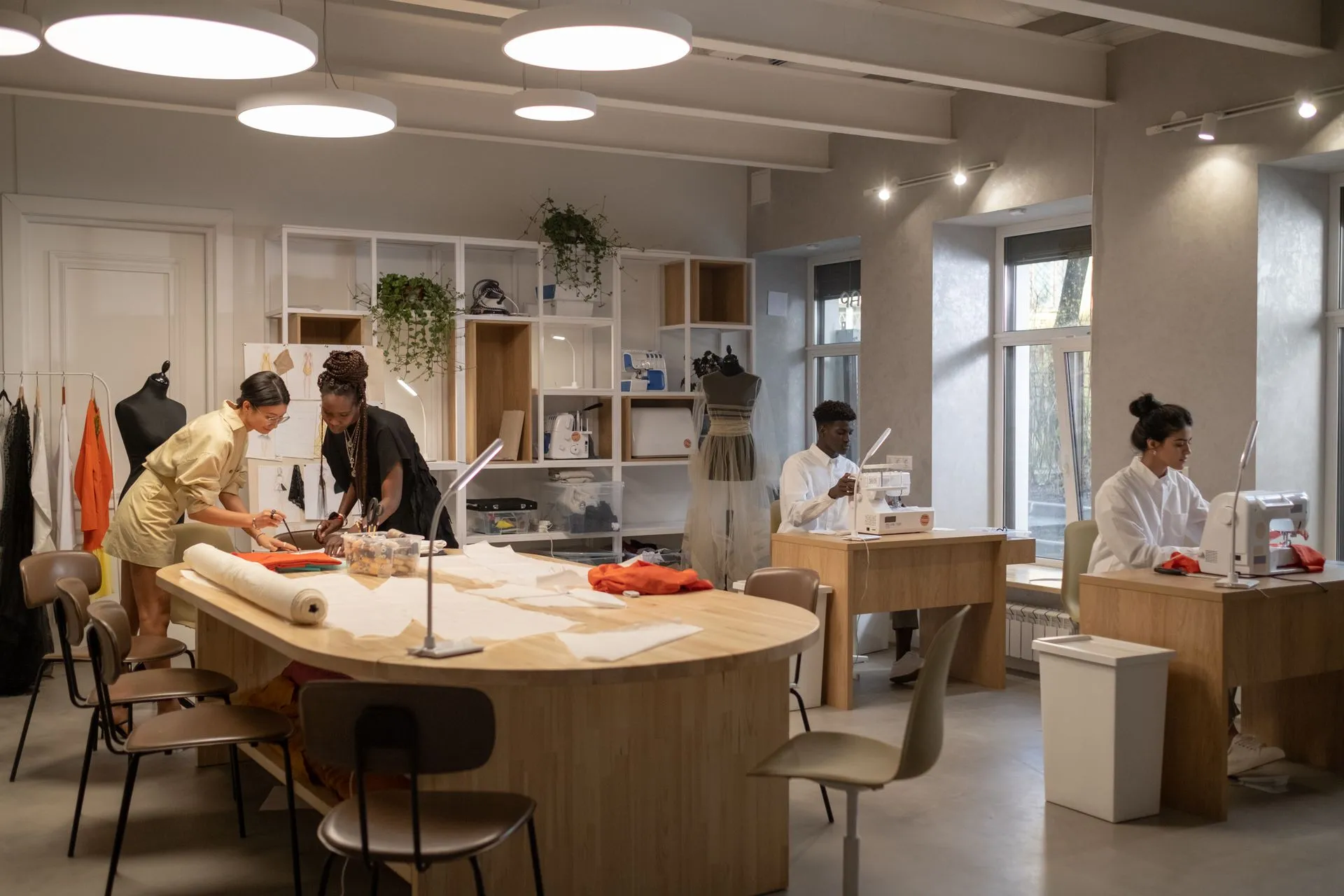 Modern design studio workspace with branded materials laid out for review