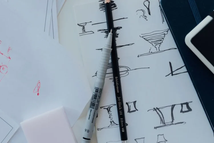 Designer workspace with logo sketches and colour swatches for logo design