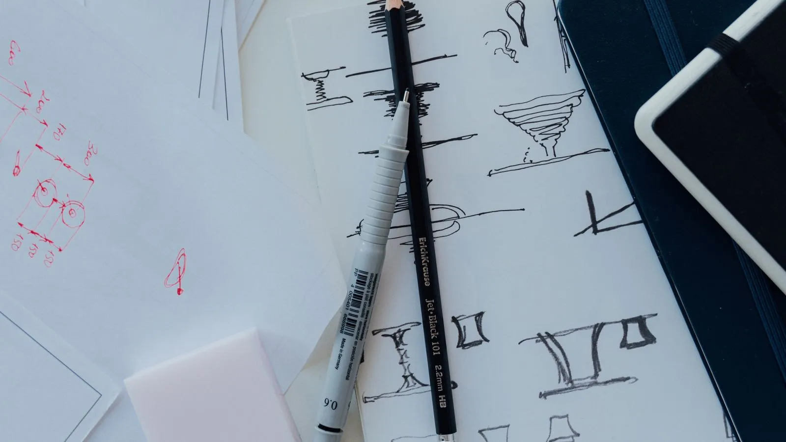 Designer workspace with logo sketches and colour swatches for logo design