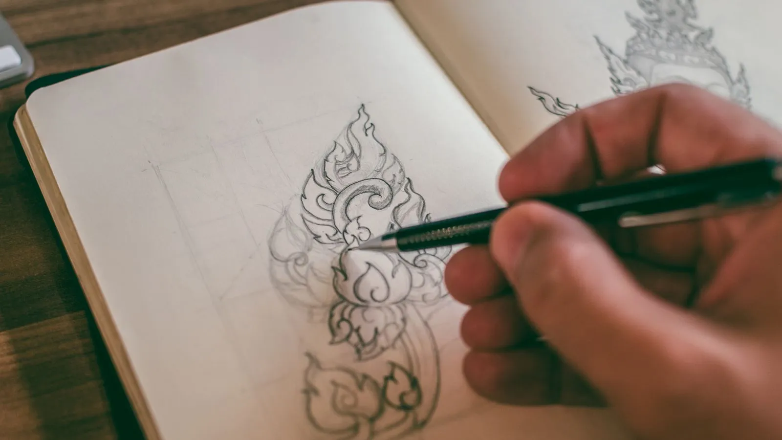Designer sketching concepts by hand during the logo design process