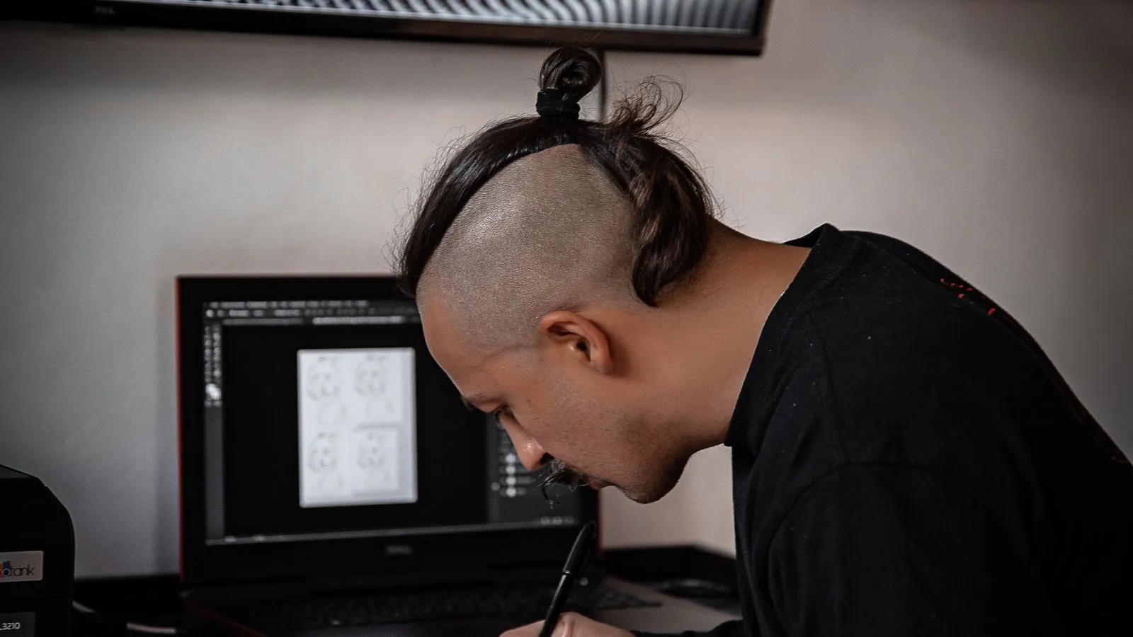 Designer refining a mark against the principles of what makes a good logo